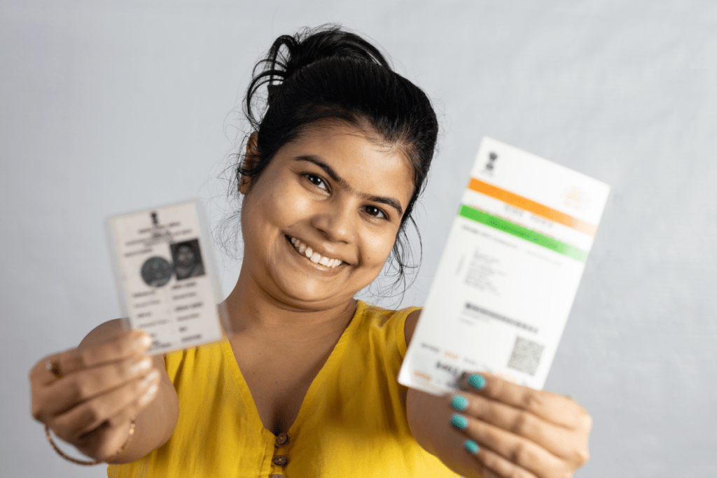 Happy individual holding newly acquired Aadhar Card thanks to Aadhar-Card.com assistance.